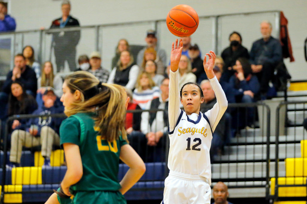 Everett’s Alana Washington hits a three point jumper against Bishop Blanchet during a first round playoff game on Tuesday, Feb. 21, 2023, at the Norm Lowery Gymnasium in Everett, Washington. (Ryan Berry / The Herald)
