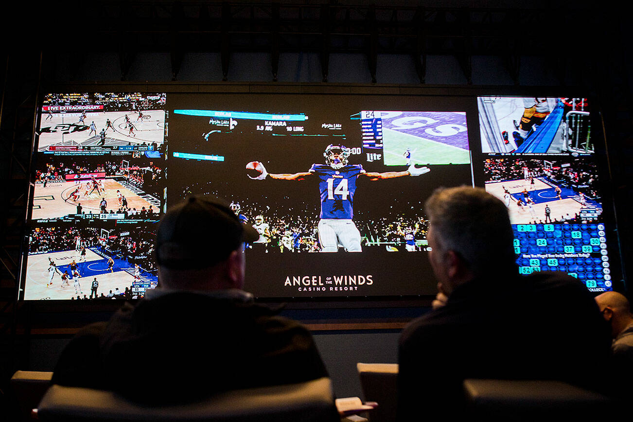 People wait for the start of the Minnesota Vikings versus the Pittsburgh Steelers football game after placing bets at Angel of the Winds Casino on Dec. 9, 2021 in Arlington. (Olivia Vanni / The Herald)