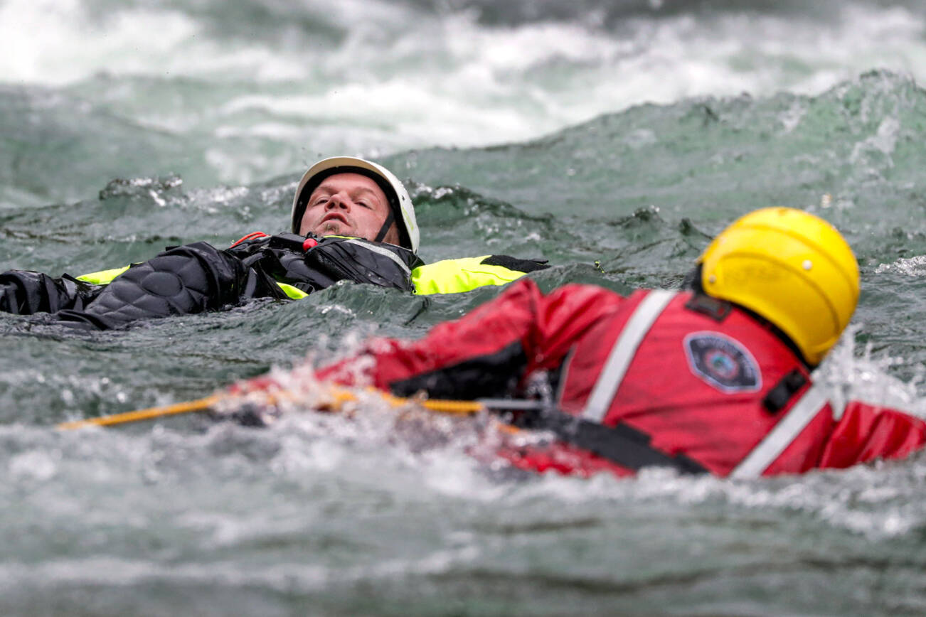 Firefighters perform a rescue during the Snohomish Regional Fire & Rescue’s annual Water Rescue Academy on the Skykomish River near Index in May, 2022. (Kevin Clark / The Herald file photo)