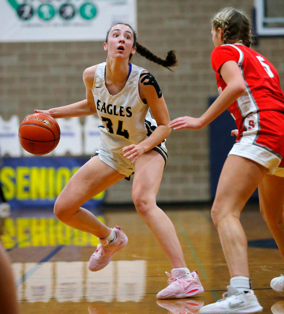 Arlington’s Jenna Villa steps back to make space for a jumper against Stanwood on Wednesday, Jan. 25, 2023, at Arlington High School in Arlington, Washington. (Ryan Berry / The Herald)
