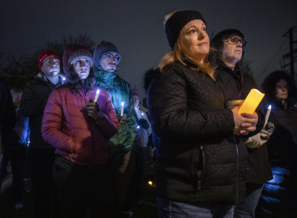 People listen to speakers Saturday at a candlelight vigil held at Drew Nielsen Neighborhood Park in Everett. (Olivia Vanni / The Herald)
