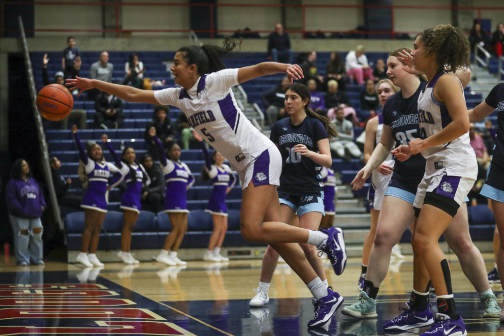 Garfield’s Imbie Jones (5) reaches for the ball during a 3A girls basketball state regional game against Meadowdale at the Courter Family Athletic Pavilion in Bellevue on Friday. Garfield won 62-48. (Annie Barker / The Herald)

