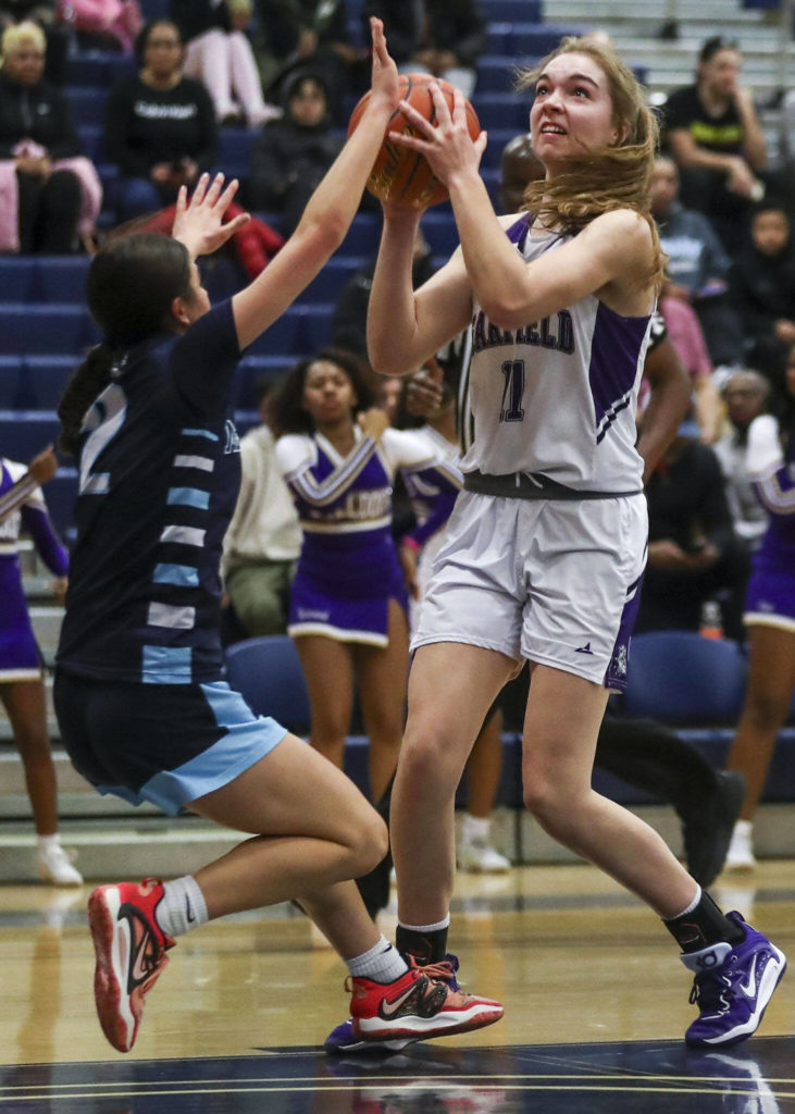 Garfield’s Sarah Lessig (11) shoots the ball during a 3A girls basketball state regional game against Meadowdale at the Courter Family Athletic Pavilion in Bellevue on Friday. Garfield won 62-48. (Annie Barker / The Herald)
