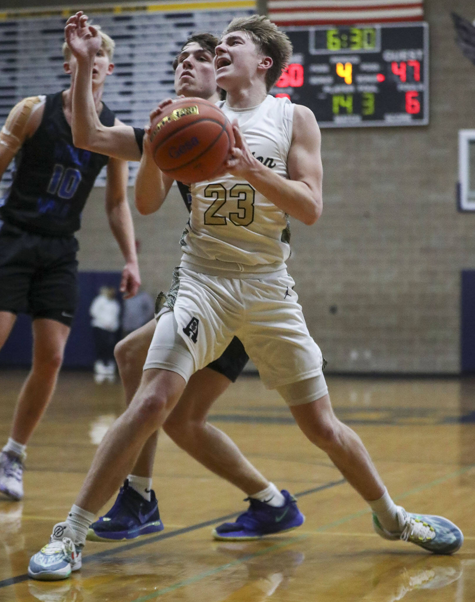 Arlington’s Leyton Martin (23) shoots the ball during a state playoff game against Walla Walla at Arlington High School on Saturday. Arlington won 68-57. (Annie Barker / The Herald)