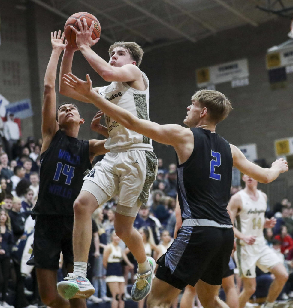 Arlington’s Leyton Martin (23) shoots the ball during a state playoff game against Walla Walla at Arlington High School on Saturday. Arlington won 68-57. (Annie Barker / The Herald)
