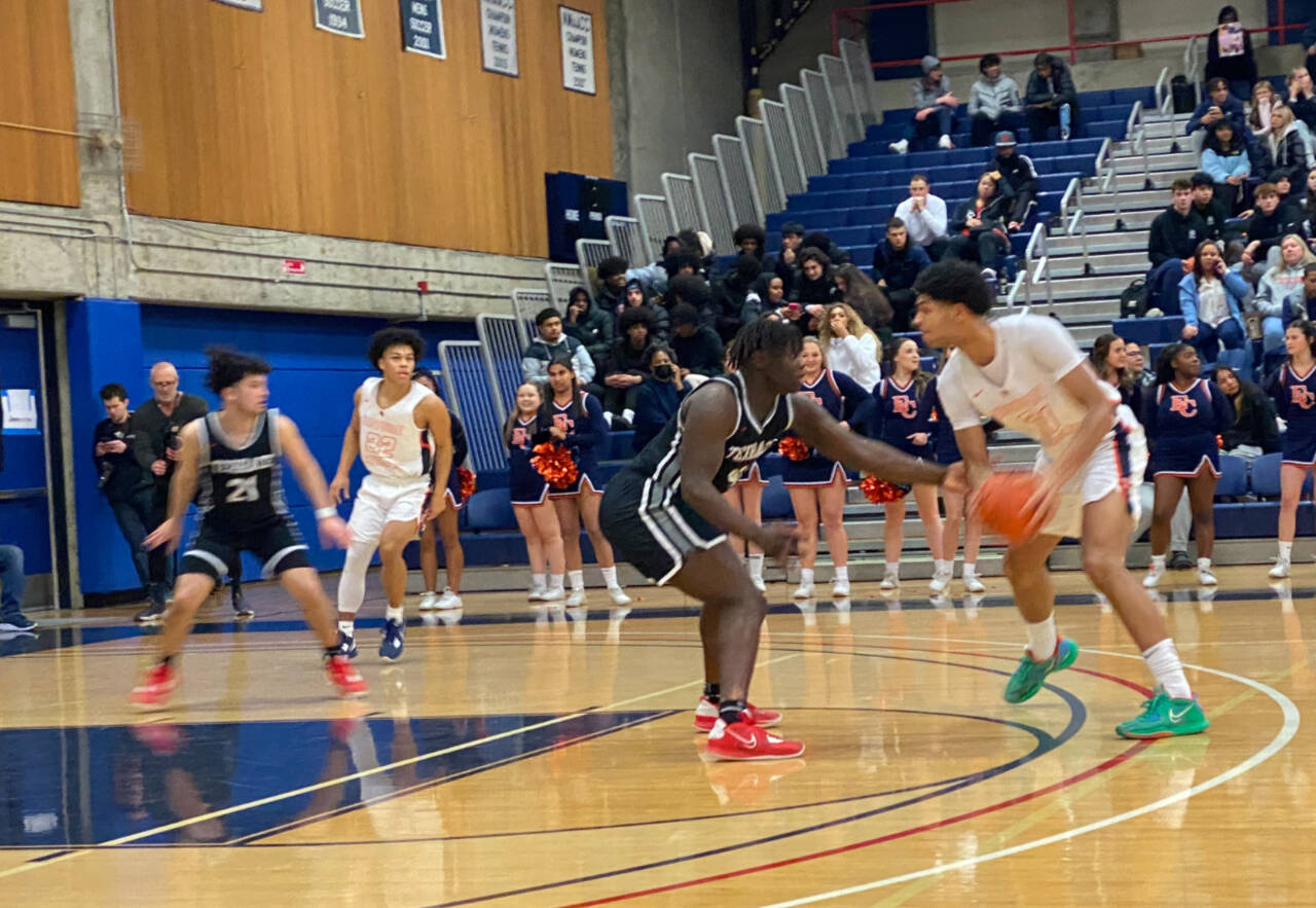 Mountlake Terrace’s Zaveon Jones (center) guards Eastside Catholic’s Jacob Cofie (right) during a state playoff game on Saturday at Bellevue College. Eastside Catholic won 54-52. (Nick Patterson / The Herald)
