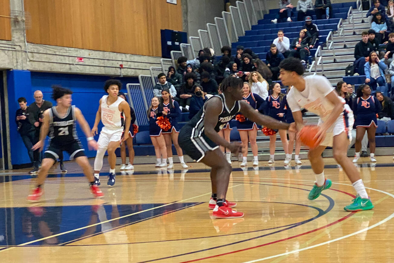 Mountlake Terrace's Zaveon Jones (center) guards Eastside Catholic's Jacob Cofie (right) during a state playoff game on Saturday, Feb. 25, 2023, at Bellevue College. Eastside Catholic won 54-52. (Nick Patterson / The Herald)