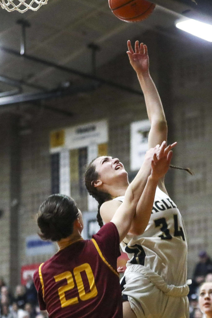Arlington’s Jenna Villa (34) shoots the ball during a state playoff game against Lakeside at Arlington High School on Saturday. Arlington won 75-63. (Annie Barker / The Herald)
