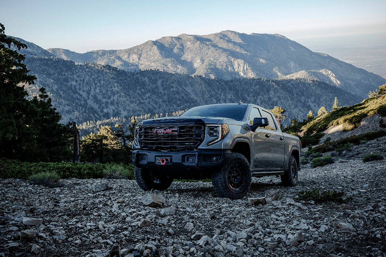 The 2023 GMC Sierra 1500 AT4X AEV Edition driving on a rocky hillside. The AT4X AEV Edition delivers extreme off-road capability without compromising on-road comfort. (GMC)