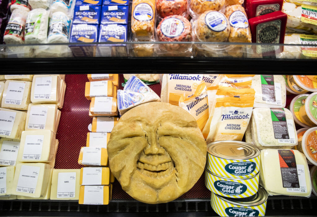 A carved round of parmesan that has been at Double DD Meats for more than 30 years is on display with their cheese selection in Mountlake Terrace. (Olivia Vanni / The Herald)
