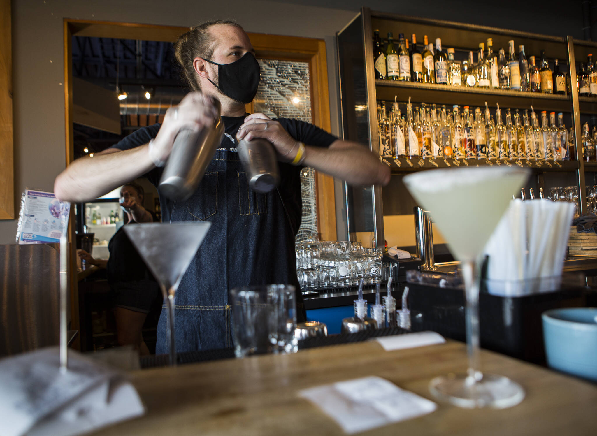 Kyle Galvin, who has worked for Bluewater for more than 4 years, makes cocktails on July 10, 2020 in Everett. (Olivia Vanni / The Herald)