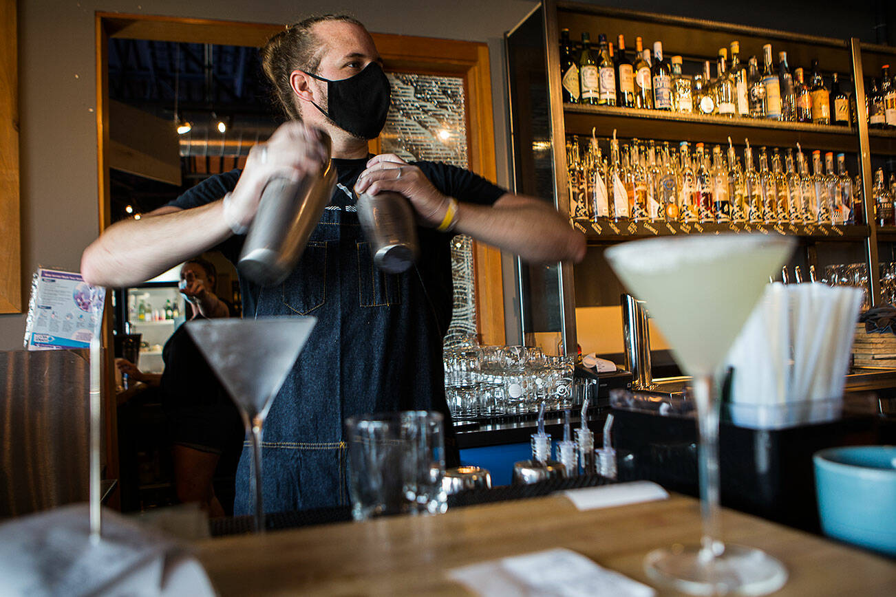 Kyle Galvin, who has worked for Bluewater for more than 4 years, makes cocktails on July 10, 2020 in Everett. (Olivia Vanni / The Herald)