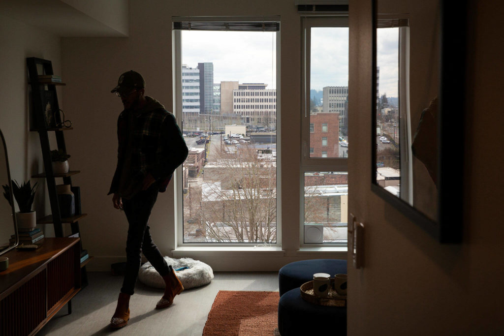 Property manager Dynasty Williams walks through a studio apartment at the Nimbus Apartments on Wednesday in downtown Everett. (Ryan Berry / The Herald)
