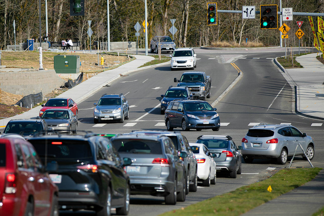 Vehicles on Soper Hill Road wait in line to make unprotected left turns onto Highway 9 northbound and southbound during the evening commute Wednesday, March 15, 2023, in Lake Stevens, Washington. (Ryan Berry / The Herald)