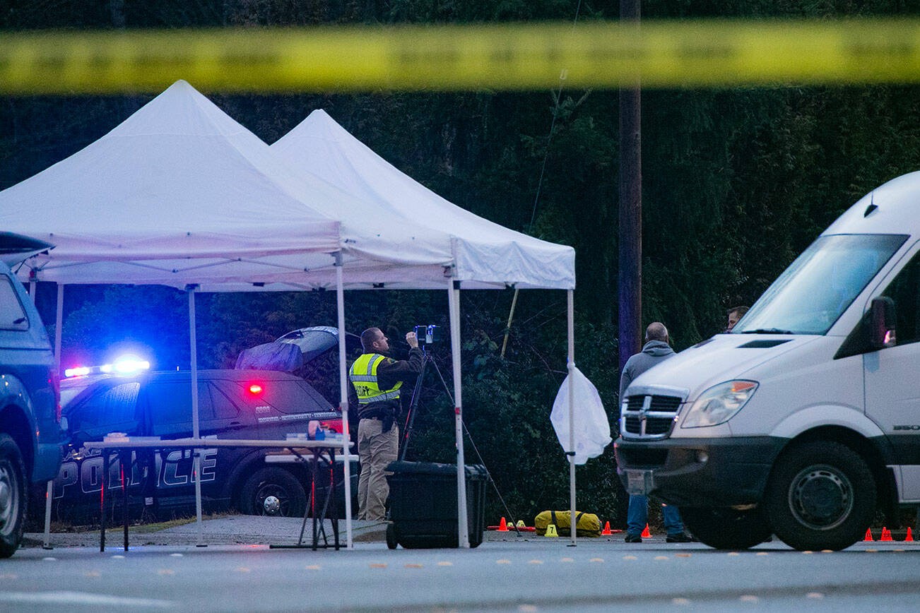 A member of the Sheriff's office works around evidence as investigators work the scene on 20th Street SE near Route 9 after police shot and killed a man suspected in a car theft on Friday, Jan. 13, 2023, in Lake Stevens, Washington. (Ryan Berry / The Herald)