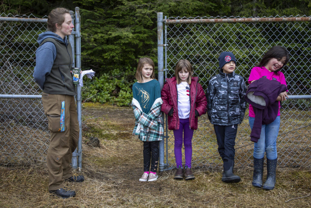 Left to right, instructor Hannah Dreesbach, Julia Hines, Emma SanCartier, Sebastian Sanchez, and Annabella Ward wait by a fence near Darrington Elementary School in Darrington on Feb. 17 in Darrington. Environmental and outdoor education lessons are woven throughout the in-school and after-school activities in this small community, thanks to the Glacier Peak Institute. The non-profit arose from community concerns in the wake of the Oso landslide disaster. (Annie Barker / The Herald)
