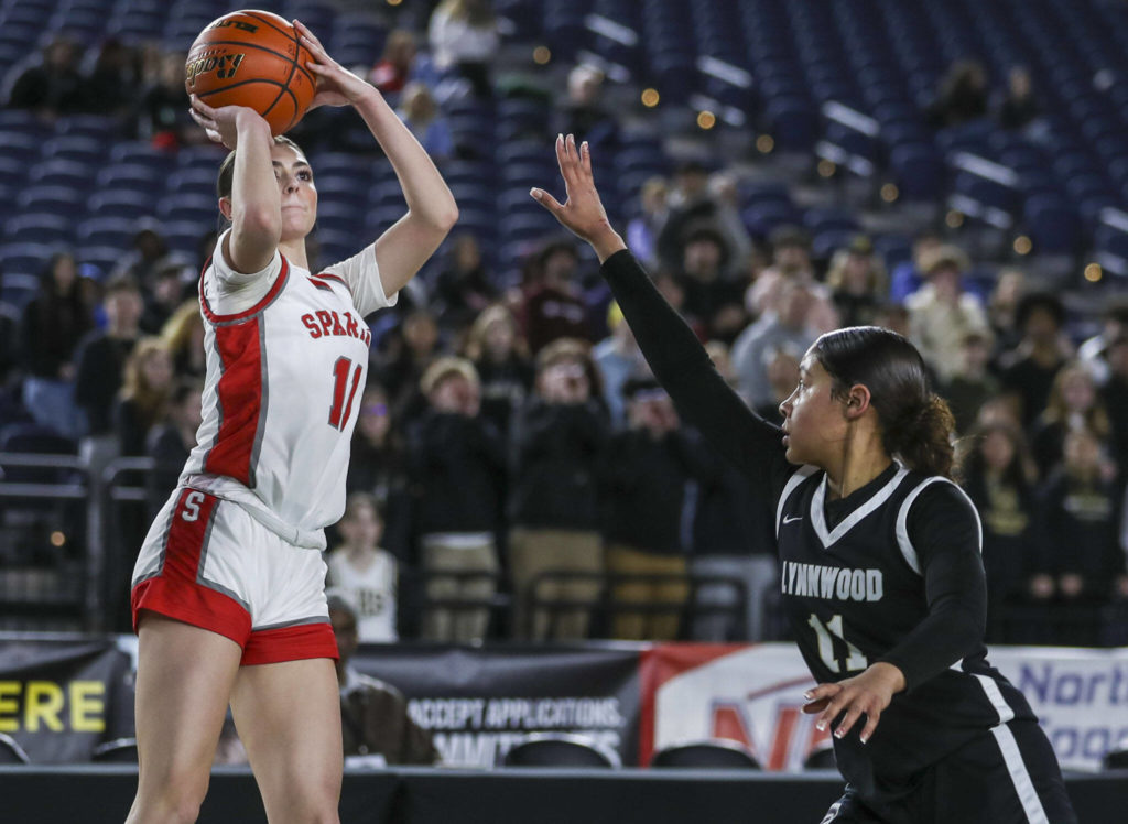 Stanwood’s Tatum Brager (11) shoots a three during a 3A girls game in the Hardwood Classic between Lynnwood and Stanwood at the Tacoma Dome in Tacoma, Washington on Wednesday, March 1, 2023. Stanwood won, 74-69. (Annie Barker / The Herald)
