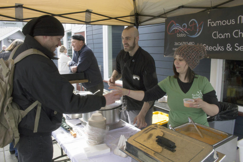 John Opheim (left) receives a tasting of chowder from Ashlee Hall (right) and Jayson Ringlein at the 2018 Musselfest. (Whidbey News-Times file photo)
