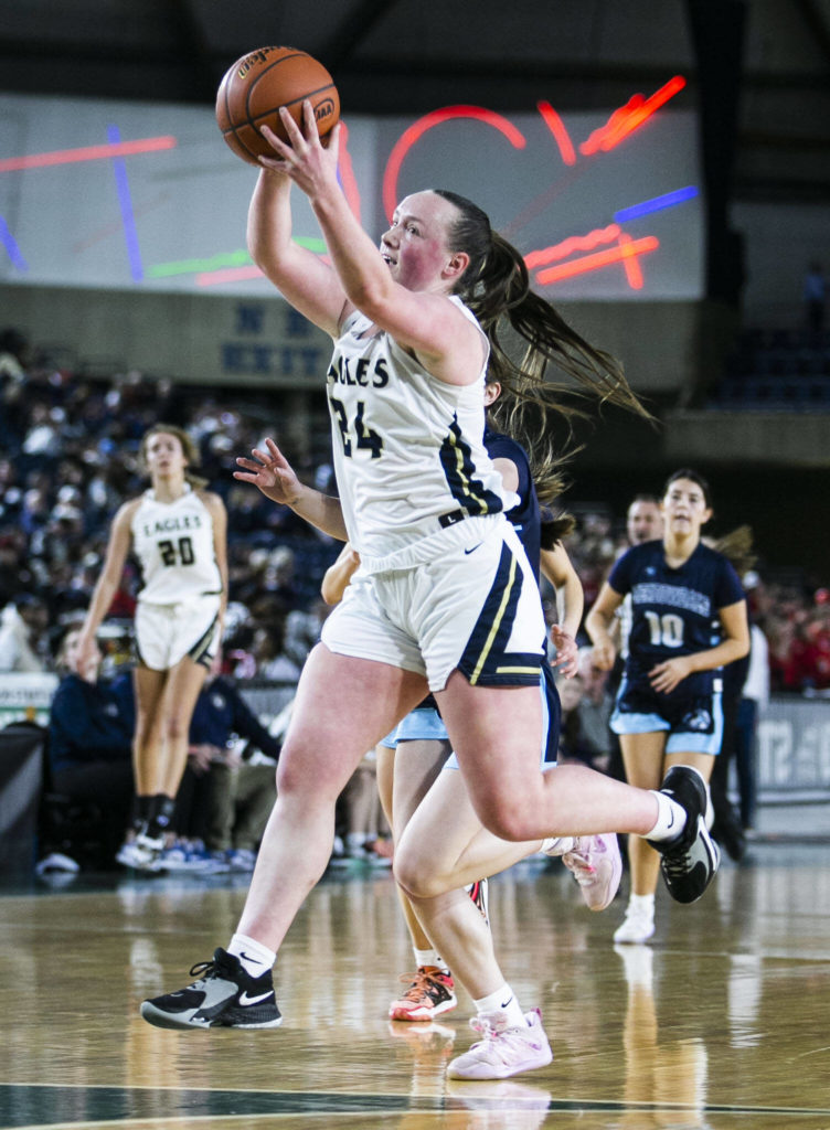 Arlington’s Katie Snow catches a high pass during the 3A quarterfinal game against Meadowdale on Thursday, March 2, 2023 in Tacoma, Washington. (Olivia Vanni / The Herald)
