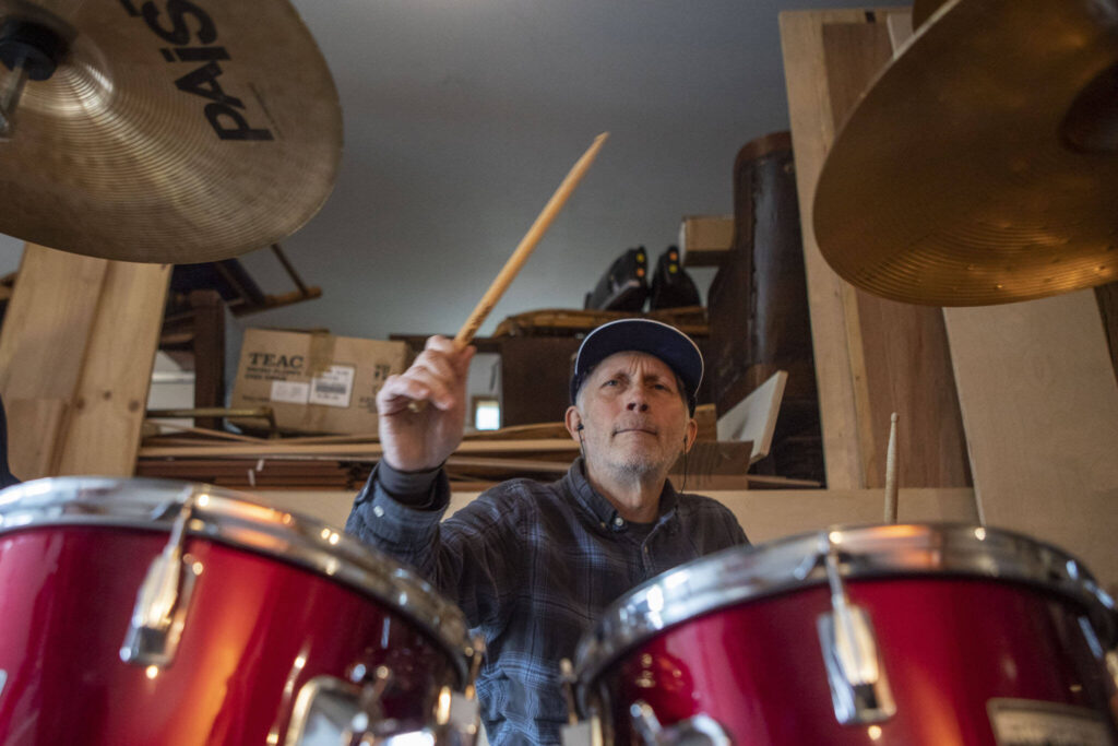 Paul Buchignani also known as “West Eastman”, plays the drums during a Dan Canyon Band rehearsal in their practice barn Saturday, March 11, 2023 in Arlington, Washington. (Annie Barker / The Herald)
