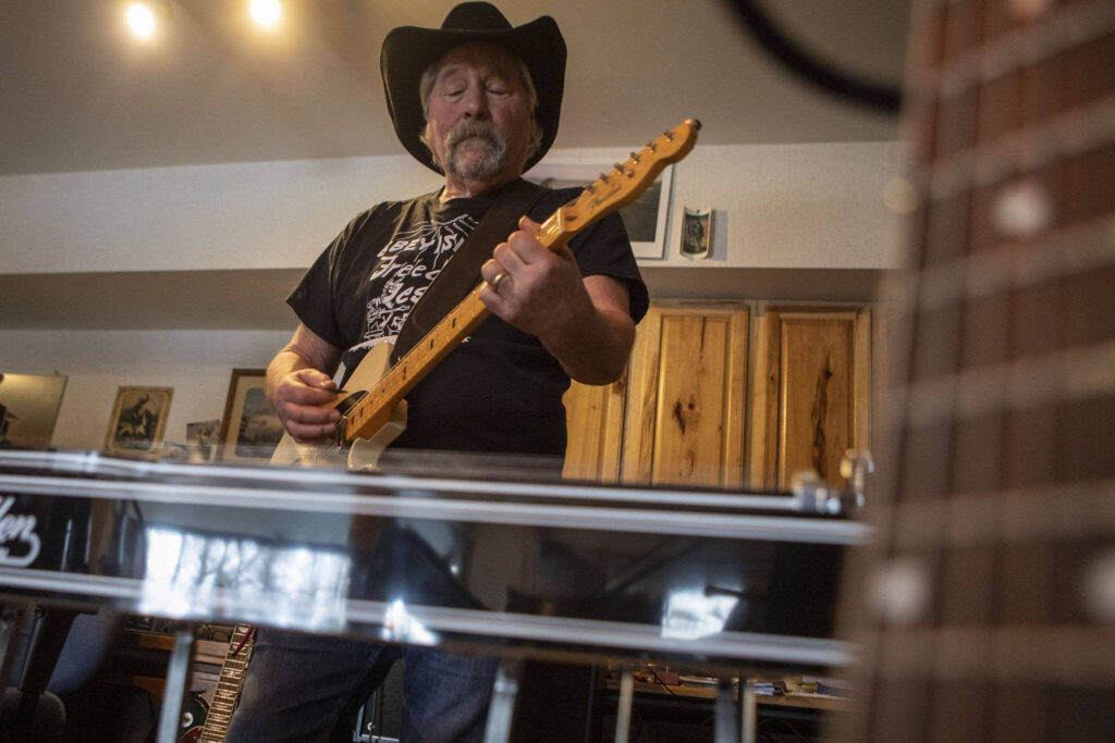 Pete Frothingham plays the guitar during a Dan Canyon Band rehearsal in their practice barn Saturday, March 11, 2023, in Arlington, Washington. (Annie Barker / The Herald)
