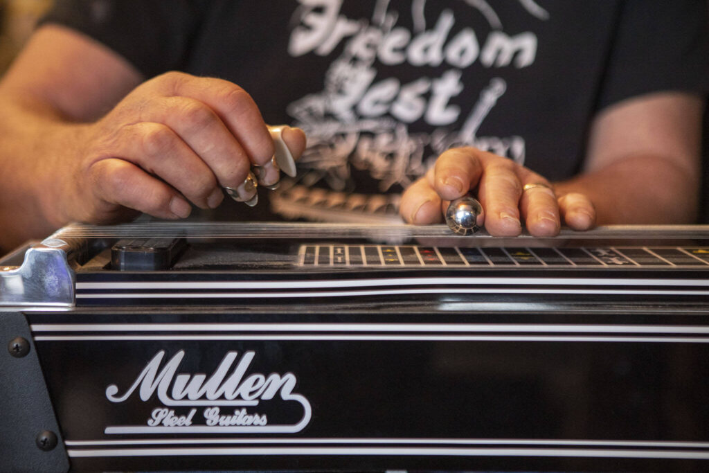 Pete Frothingham plays the pedal steel guitar during a Dan Canyon Band rehearsal in the group’s practice barn in Arlington, Washington, on Saturday, March 11, 2023. (Annie Barker / The Herald)
