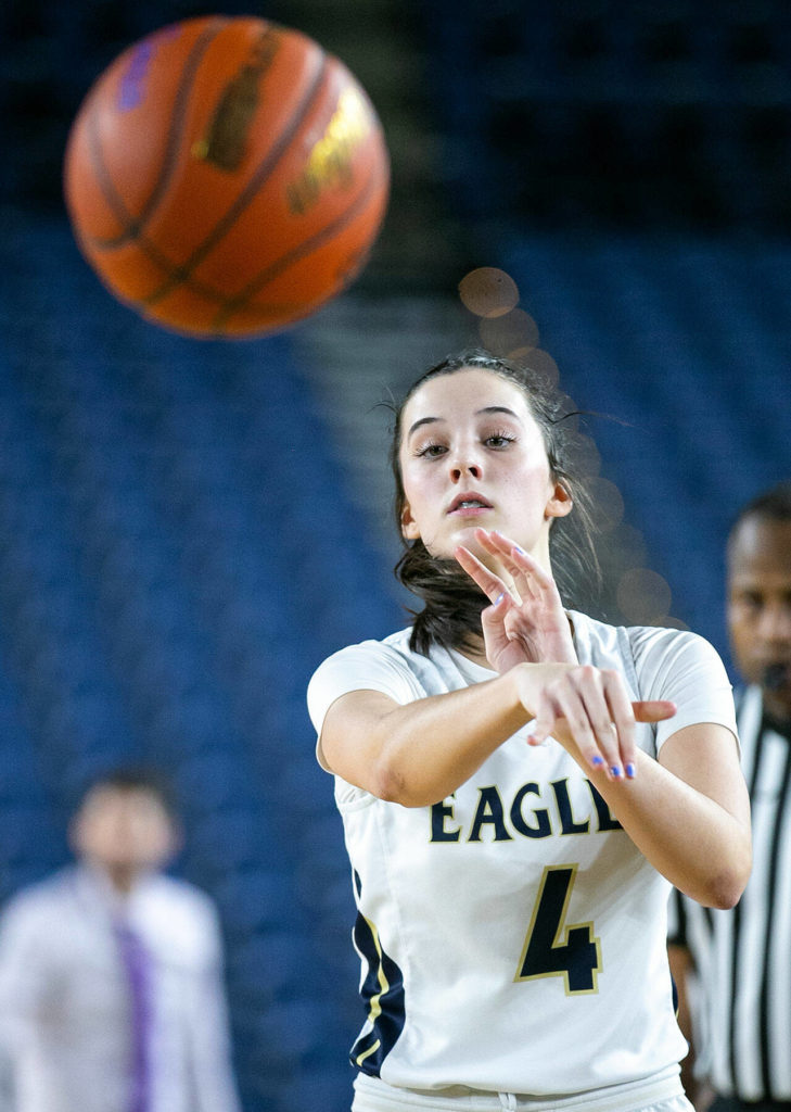 Arlington’s Maddy Fischer passes to the corner while playing against Lake Washington in the 3A semifinal on Friday, March 3, 2023, at the Tacoma Dome in Tacoma, Washington. (Ryan Berry / The Herald)
