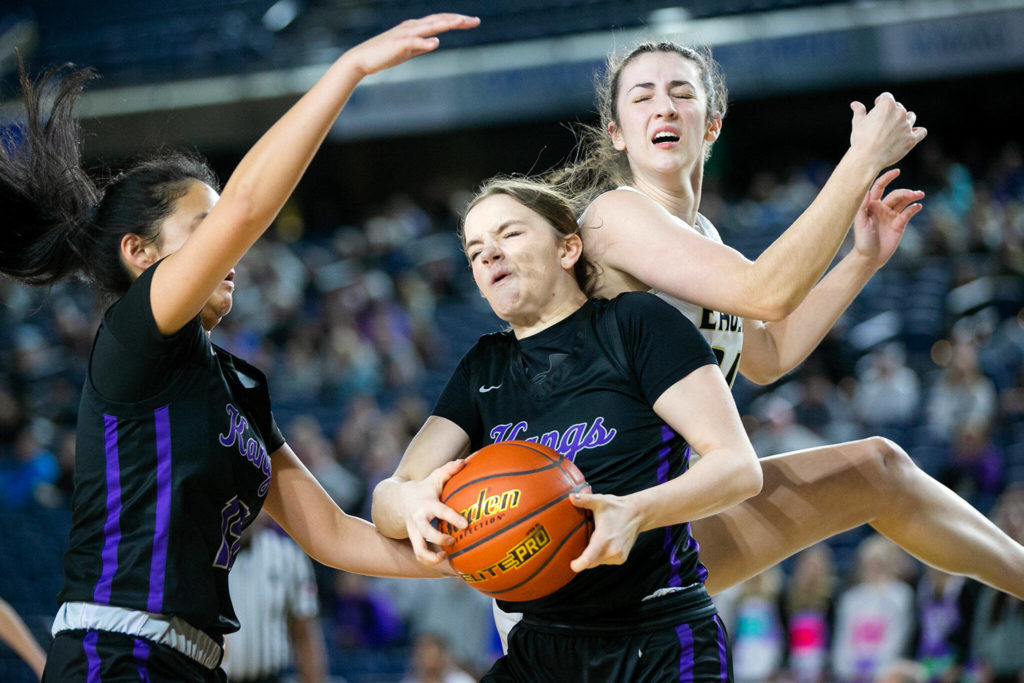 Lake Washington’s Ava Uusitalo comes down with a rebound against Arlington in the 3A semifinal on Friday, March 3, 2023, at the Tacoma Dome in Tacoma, Washington. (Ryan Berry / The Herald)
