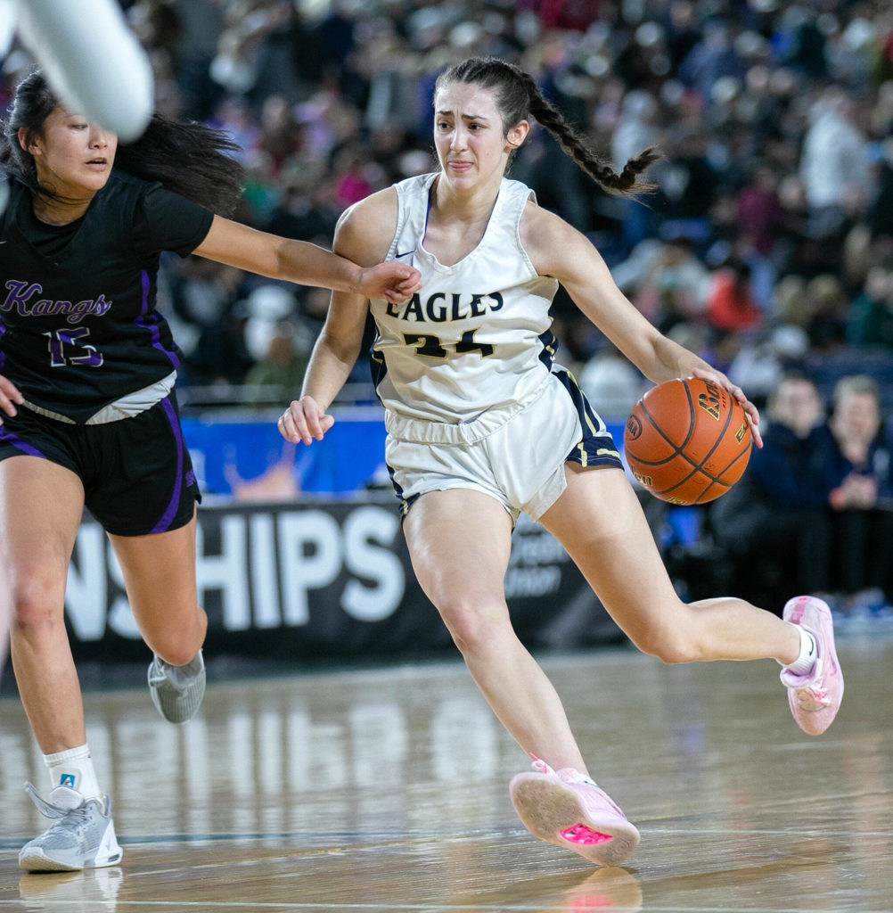 Arlington’s Jenna Villa tries to get through to the paint against Lake Washington in the 3A semifinal on Friday, March 3, 2023, at the Tacoma Dome in Tacoma, Washington. (Ryan Berry / The Herald)
