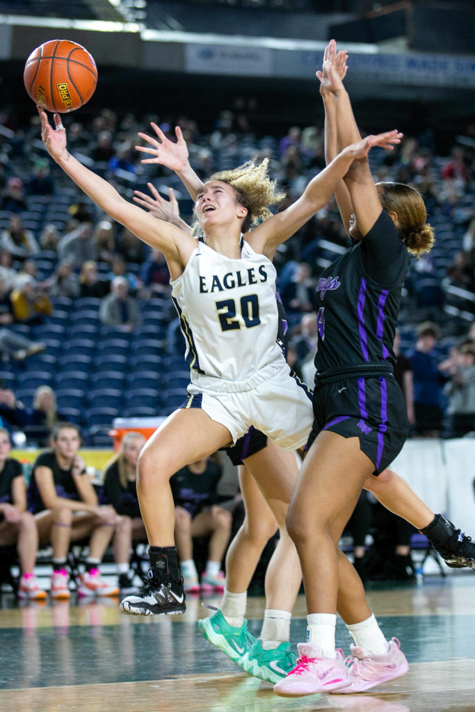 Arlington’s Samara Morrow gets fouled while trying to put up a shot against Lake Washington in the 3A semifinal on Friday, March 3, 2023, at the Tacoma Dome in Tacoma, Washington. (Ryan Berry / The Herald)
