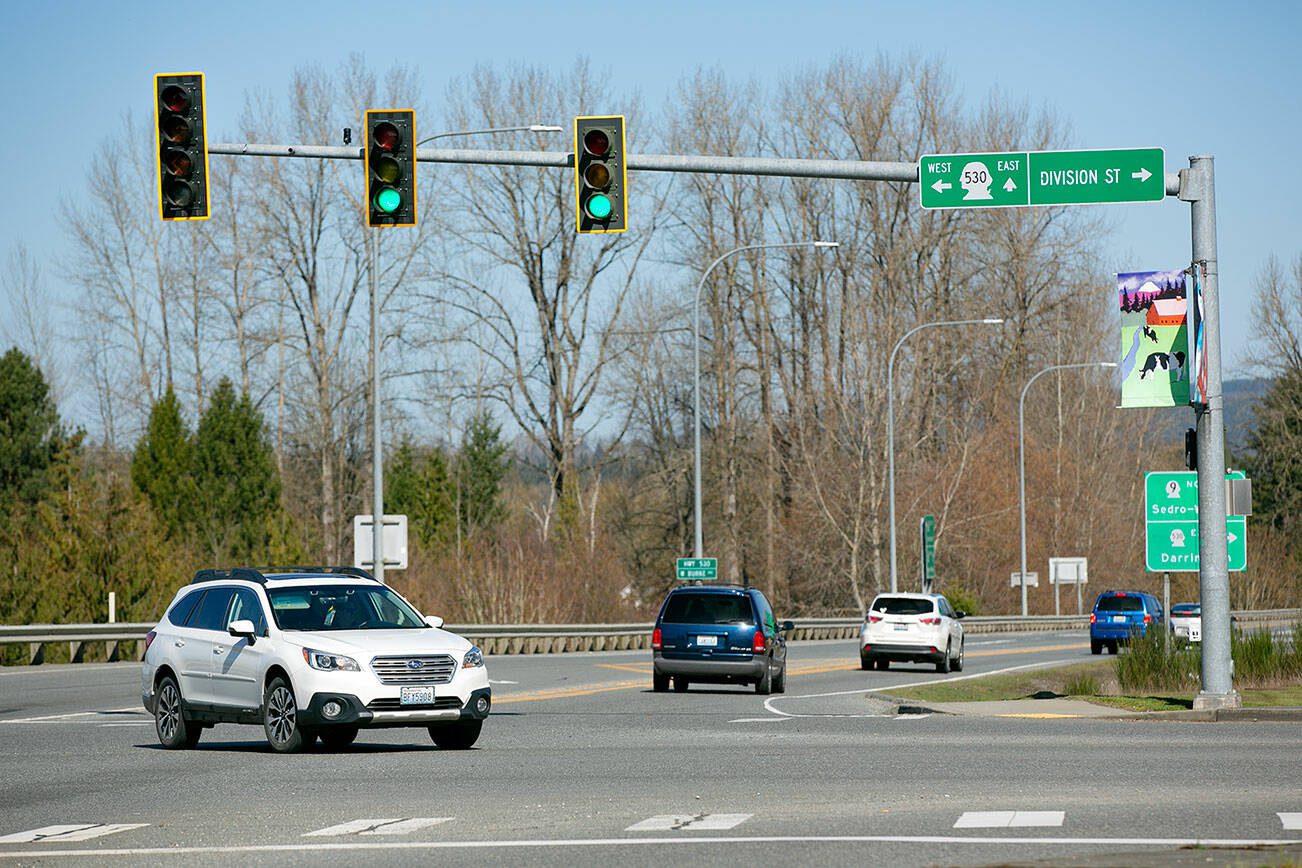 A vehicle makes an unprotected left turn on a flashing yellow arrow at the intersection of Highway 9 and Highway 530 on Wednesday, March 22, 2023, in Arlington, Washington. (Ryan Berry / The Herald)