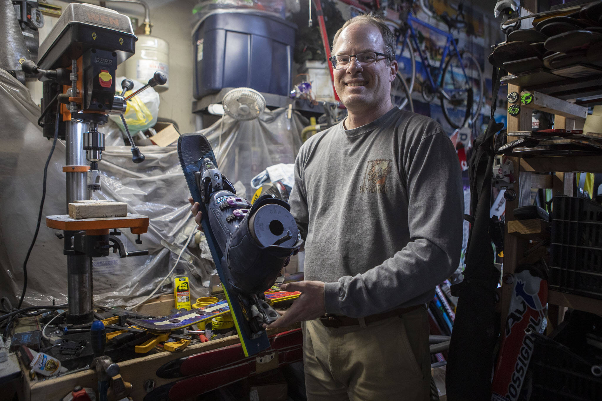 Brian Geppert displays a birdhouse made of skis at his home in Lynnwood. Geppert turns skis into functional art. (Annie Barker / The Herald)
