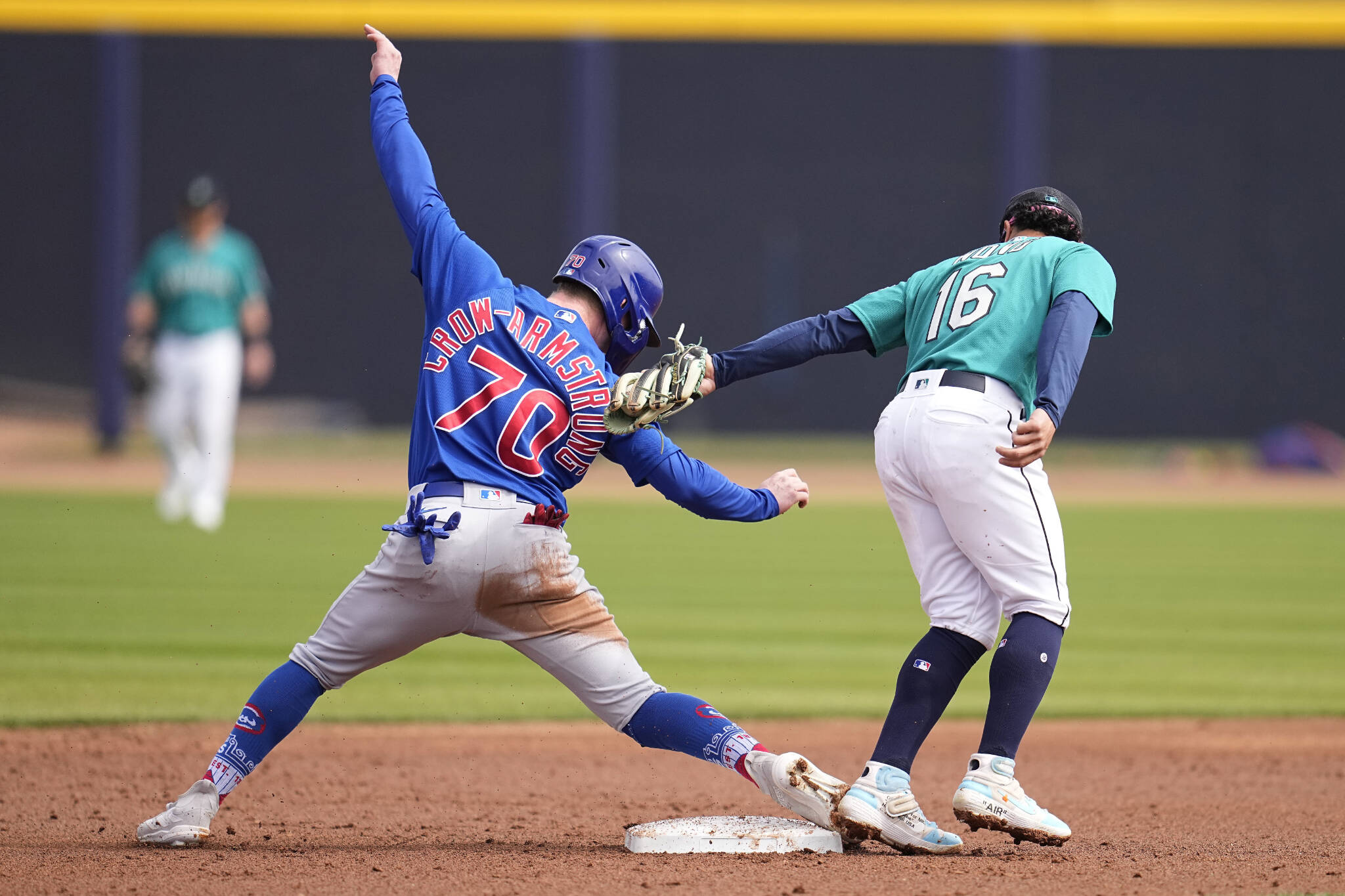 The Cubs’ Pete Crow-Armstrong (70) beats a tag by Mariners second baseman Kolten Wong (16) to steal second base during the second inning of a spring training game Monday in Peoria, Ariz. (AP Photo/Abbie Parr)