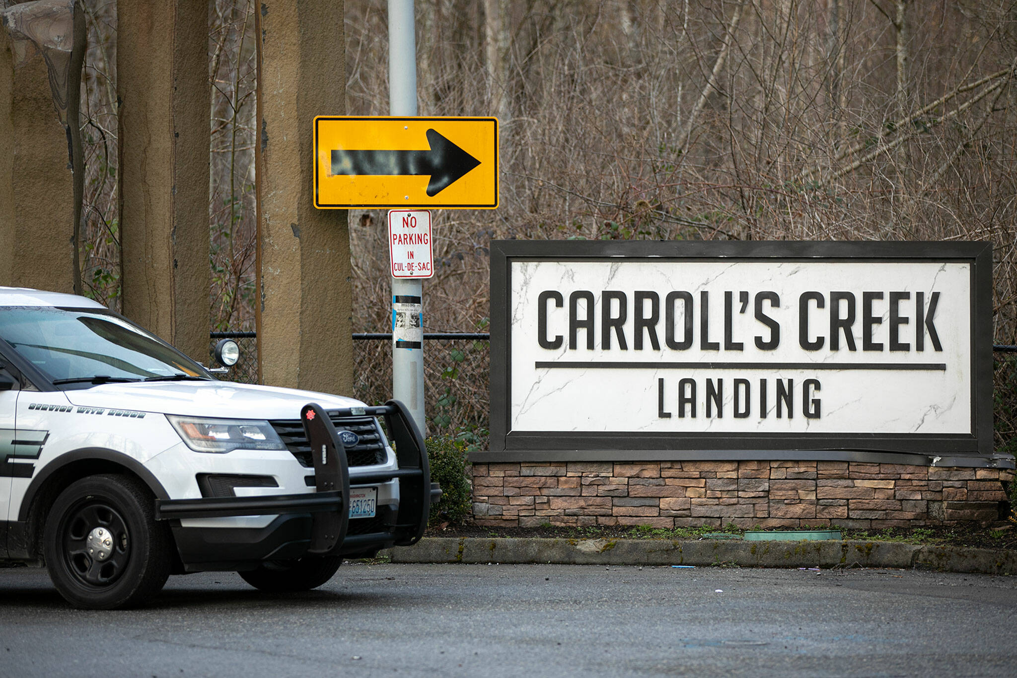 A Marysville Police vehicle is parked outside Carroll’s Creek Landing after a car chase ended with a crash in the apartment complex on Monday, March 6, in Marysville, Washington. (Ryan Berry / The Herald)