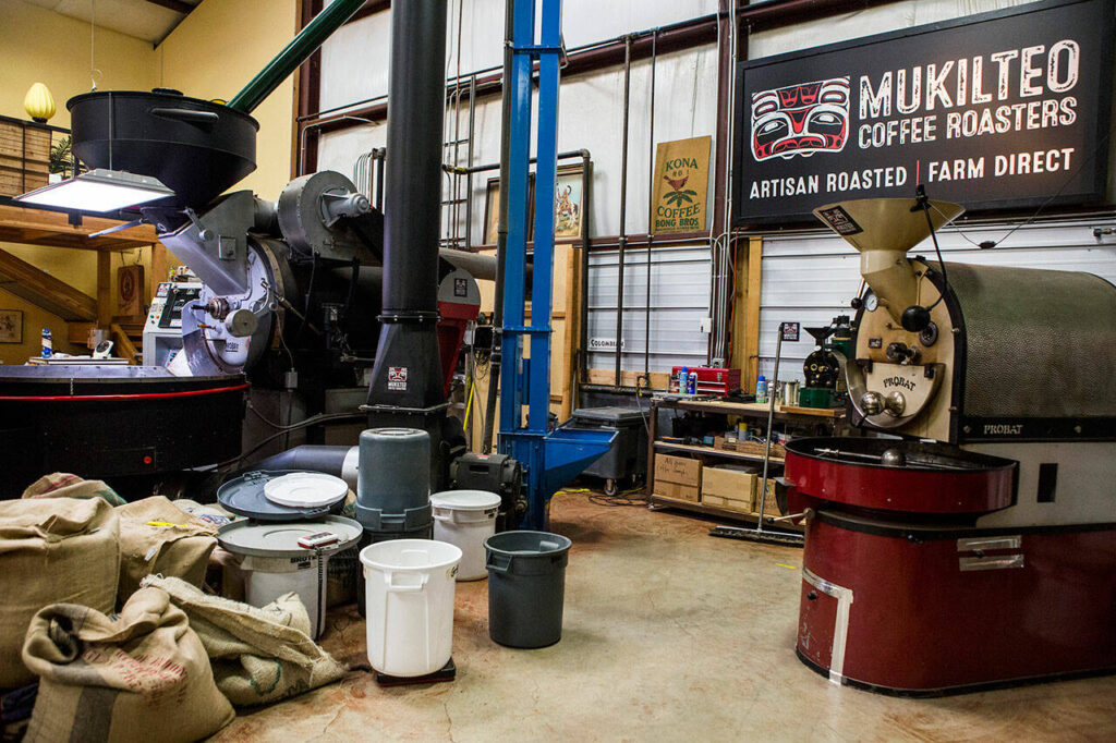 Two large industrial coffee roasters sit in one of two roastery buildings at Mukilteo Coffee Roasters on Oct. 10, 2018 in Langley, Washington. (Olivia Vanni / The Herald)
