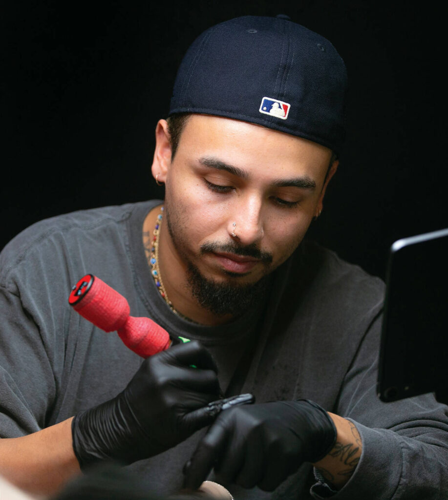 Hurtado works in a tattoo style called “fine line.” (Ryan Berry / The Herald)
