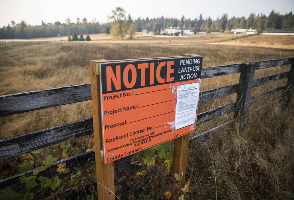 A notice, seen here Oct. 13, 2022, at the site of the proposed mental health facility at 300th Street NW and 80th Avenue NW north of Stanwood. (Olivia Vanni / Herald file)
