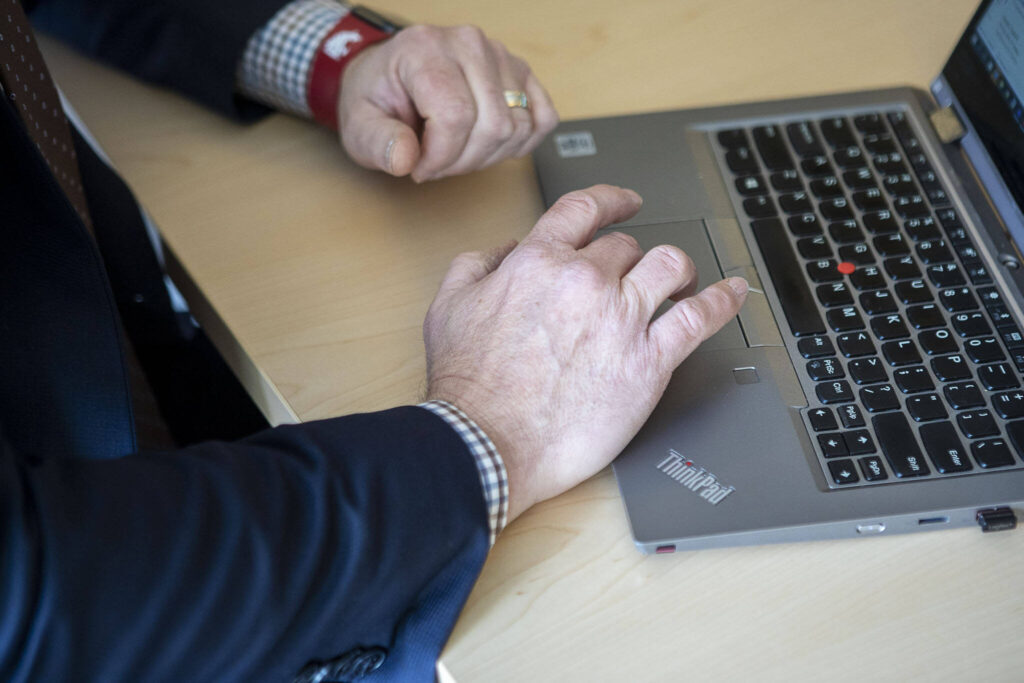 Everett Public Schools chief information officer, Brian Beckley, pulls open a document at the Everett Public Schools Community Resource Center on Tuesday, March 21, 2023 in Everett, Washington. (Annie Barker / The Herald)
