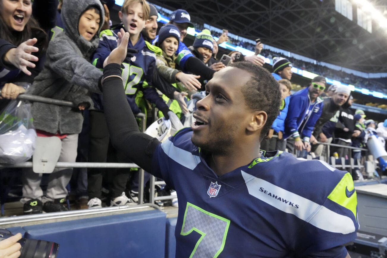 Seattle Seahawks quarterback Geno Smith (7) celebrates with fans after an NFL football game against the New York Jets , Sunday, Jan. 1, 2023, in Seattle. The Seahawks defeated the Jets 23-6. (AP Photo/Ted S. Warren)