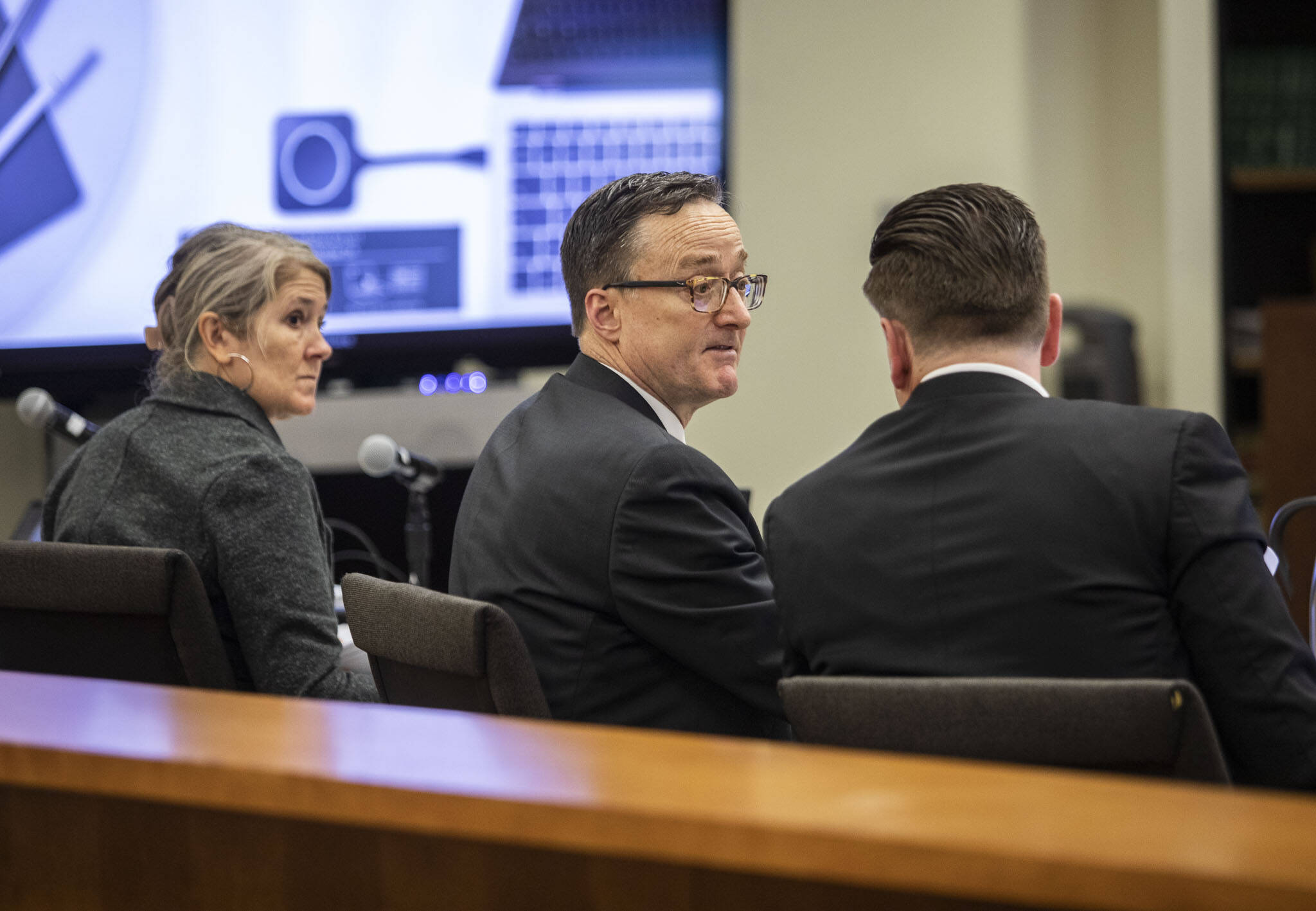 Defense attorney Natalie Tarantino, left, listens while prosecutors Craig Matheson, center, and Bob Langbehn, right, discuss a juror during jury selection at the Snohomish County Courthouse on Tuesday, March 14, 2023 in Everett, Washington. (Olivia Vanni / The Herald)