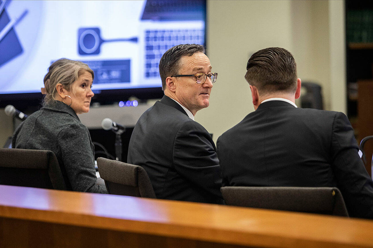 Defense attorney Natalie Tarantino, left, listens while prosecutors Craig Matheson, center, and Bob Langbehn, right, discuss a juror during jury selection at the Snohomish County Courthouse on Tuesday, March 14, 2023 in Everett, Washington. (Olivia Vanni / The Herald)