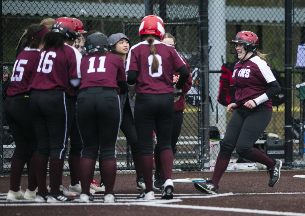 Cascade’s Alexa Hamshaw is congratulated by her teammates after hitting a home run during the game against Lakewood on Monday, March 13, 2023 in Everett, Washington. (Olivia Vanni / The Herald)
