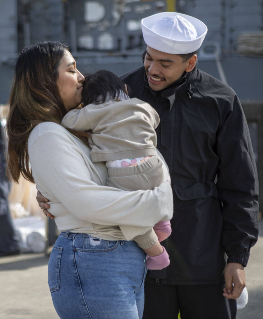 Left to right, Saharah Mendoza, Cielo Mendoza and Octavio Mendoza, reunite in Everett, Washington on Friday, March 17, 2023. The USS Barry arrived to its new homeport at Everett Naval Station, previously from Yokosuka, Japan. The crew is led by Commanding Officer, Cmdr. Grant Bryan. (Annie Barker / The Herald)
