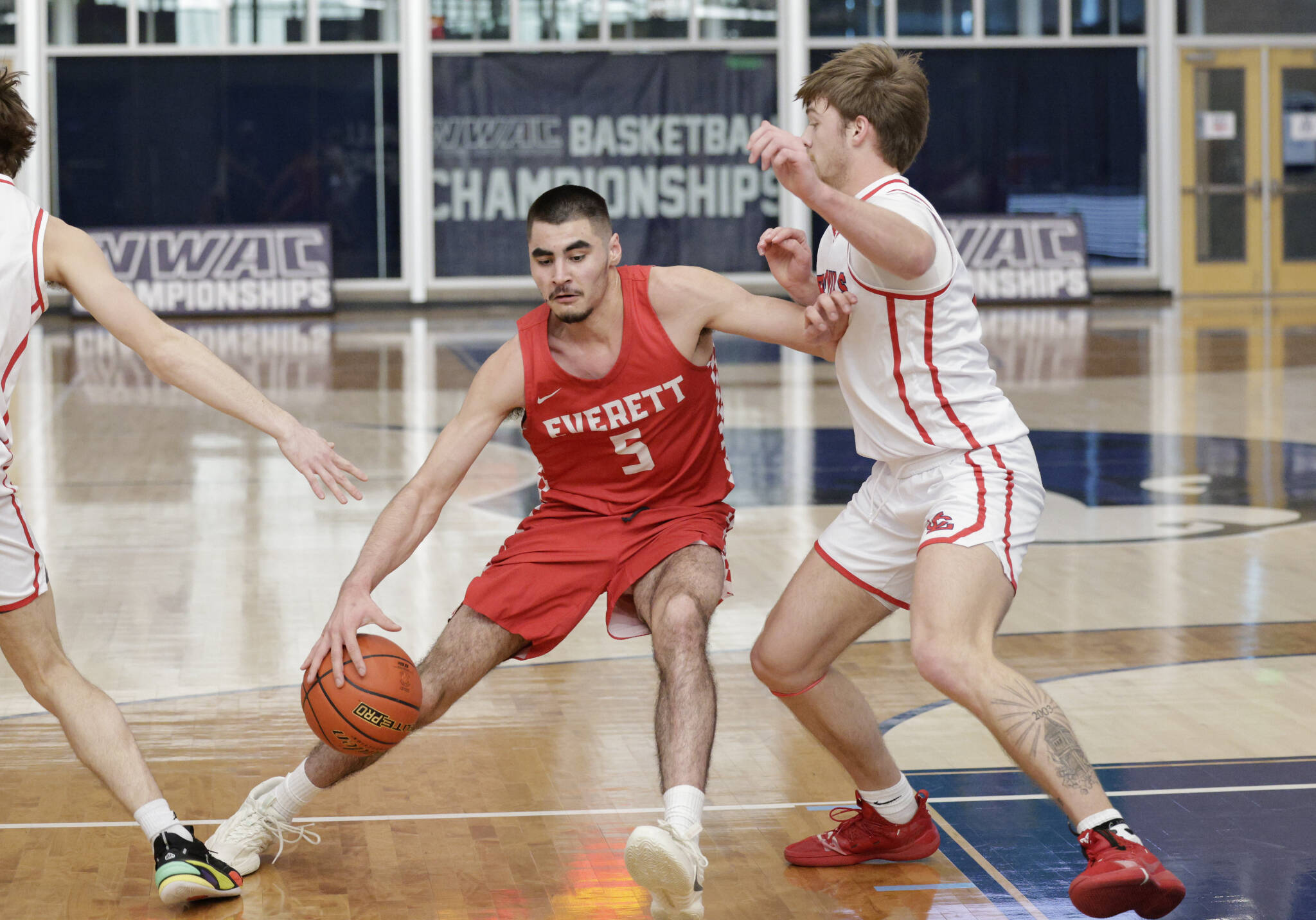 Everett Community College’s Tucker Molina (left) drives to the basket during a NWAC men’s tournament quarterfinal game against Lower Columbia on Saturday, March 11, 2023, at Columbia Basin College in Pasco. (Dan Acosta / EvCC Athletics)