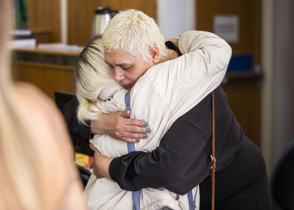 Xochitl Hofland, the mother of victim Andre Hofland, hugs a friend Wednesday after Dominic Wilson’s sentencing at the Snohomish County Courthouse in Everett. (Olivia Vanni / The Herald)
