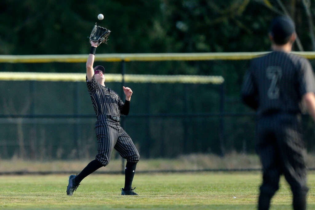 Lynnwood’s Keenan Masters snags a fly ball in center field during a game against Lake Stevens on Friday, March 17, 2023, at Lake Stevens High School in Lake Stevens, Washington. (Ryan Berry / The Herald)
