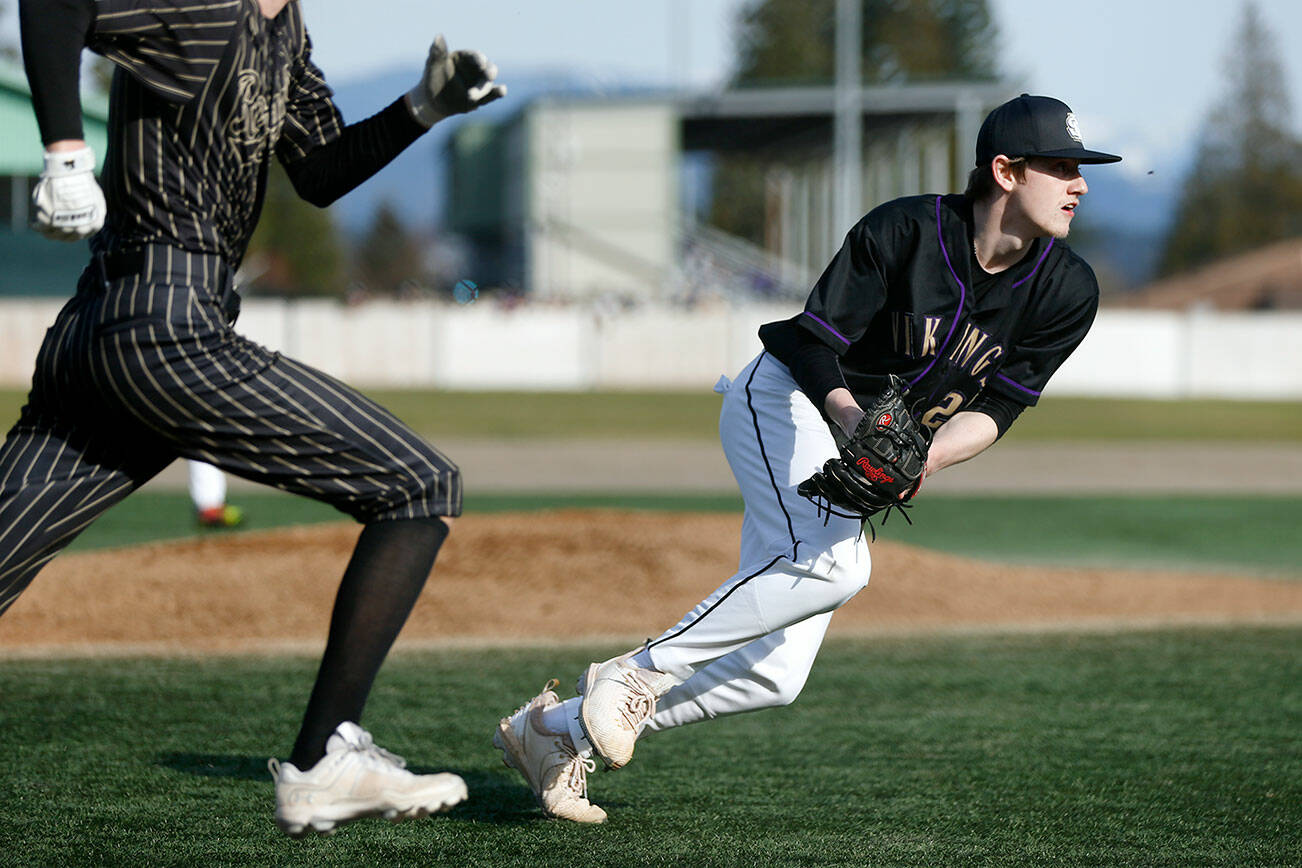 Lake Stevens pitcher Kaiden Sekely fields a bunt and throws out the runner during a game against Lynnwood on Friday, March 17, 2023, at Lake Stevens High School in Lake Stevens, Washington. (Ryan Berry / The Herald)