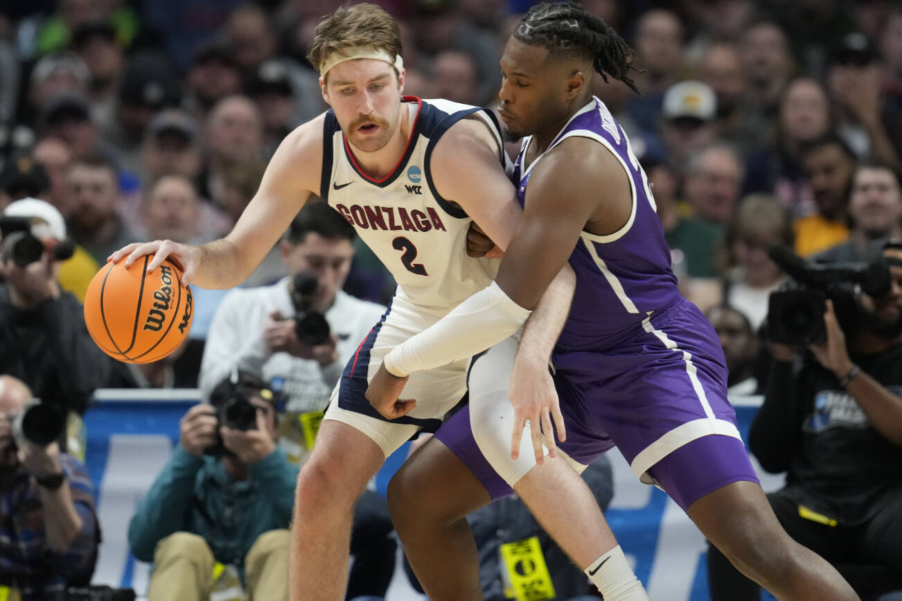 Gonzaga forward Drew Timme, left, looks to move the ball as Grand Canyon forward Yvan Ouedraogo defends in the second half of a first-round college basketball game in the men's NCAA Tournament, Friday, March 17, 2023, in Denver. (AP Photo/David Zalubowski)