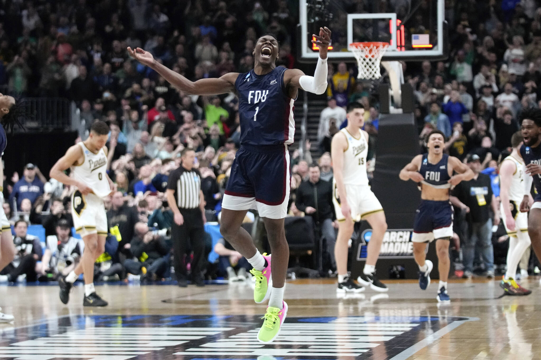 Fairleigh Dickinson guard Joe Munden Jr. (1) celebrates beating Purdue 63-58 in first-round NCAA Tournament game on Friday in Columbus, Ohio. (AP Photo/Paul Sancya)