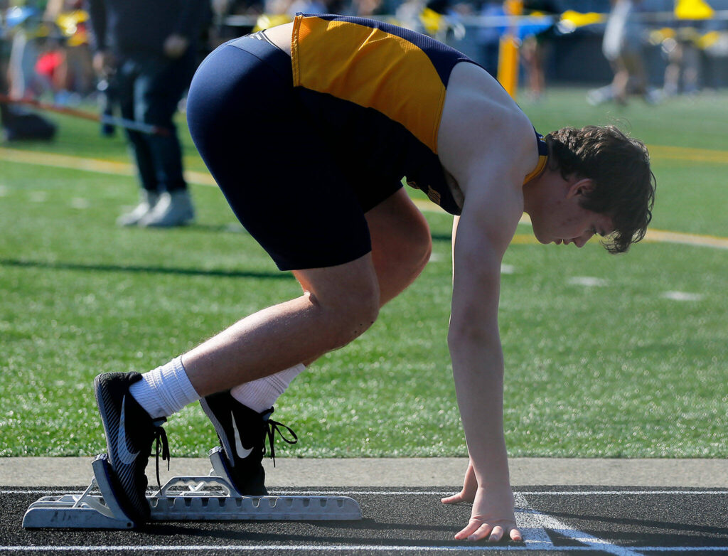 A runner takes his mark before the 300 meter hurdle during the Chuck Randall Invite at Arlington High School on Saturday, March 18, 2023, in Arlington, Washington. (Ryan Berry / The Herald)
